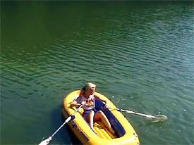 Naked girl on inflatable boat