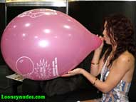 Karlie blows up balloon